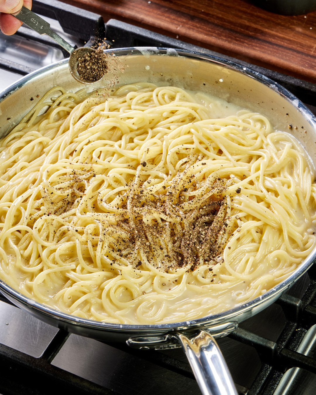 8. Off heat, toss in 1 teaspoon of pepper, then let stand briefly to allow the sauce to “tighten.” Toss again. Taste and season with additional salt, if needed.