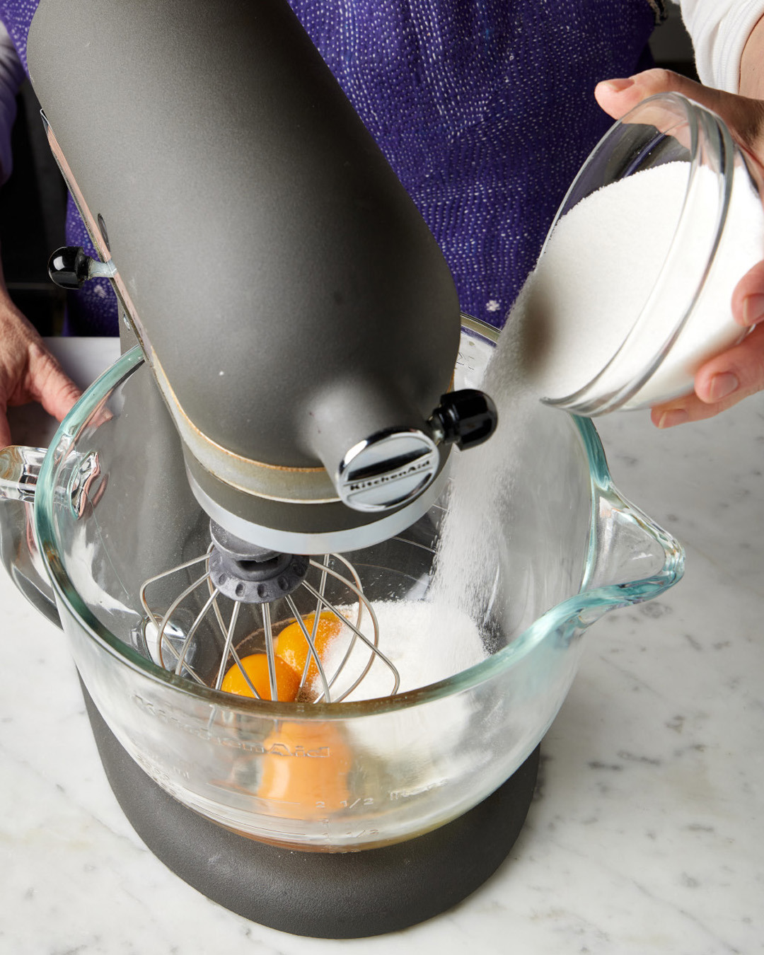3. In a stand mixer with the whisk attachment, beat the whole egg and yolks, the remaining sugar and the lemon zest on medium until the ingredients are combined, about 30 seconds.