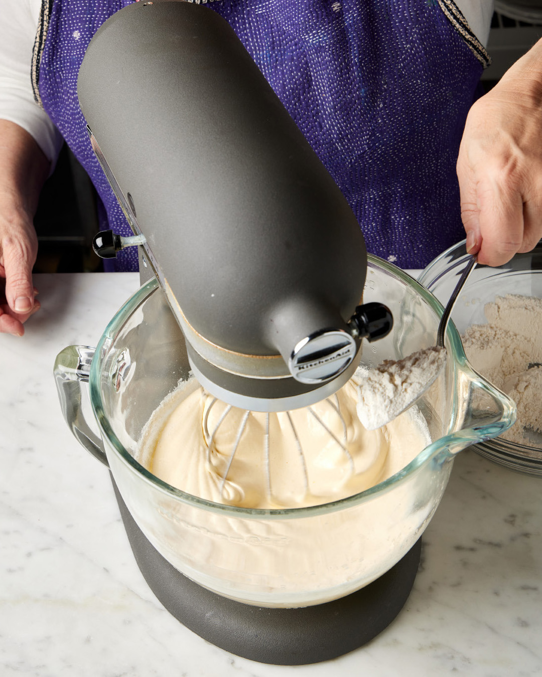 6. With the mixer again running on low, add the flour mixture in three or four additions, mixing until the dry ingredients are almost fully incorporated before adding more.