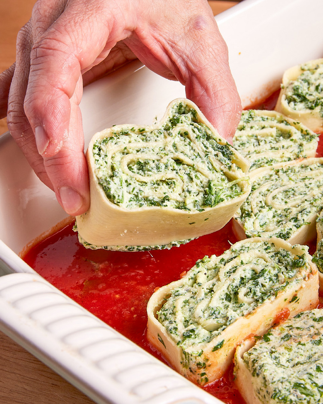 7. Arrange the slices cut side up in a single layer over the sauce. Tightly cover the baking dish with foil and bake until the sauce is bubbling, 35 to 40 minutes.