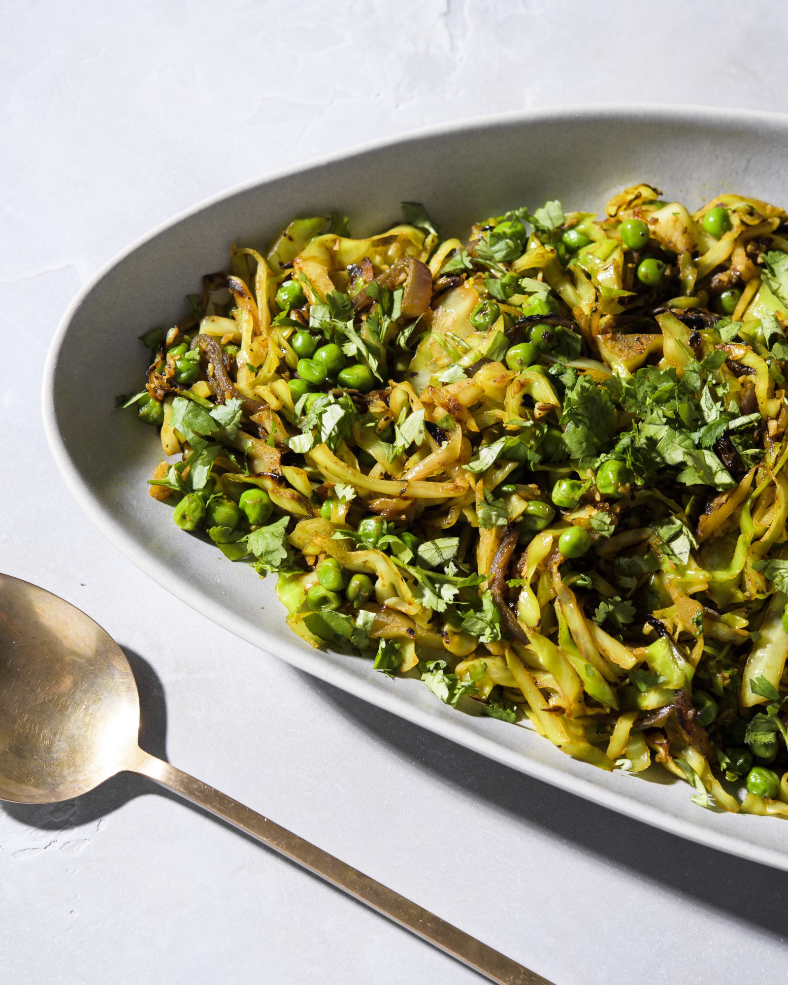 Spicy stir fried cabbage onion peas v