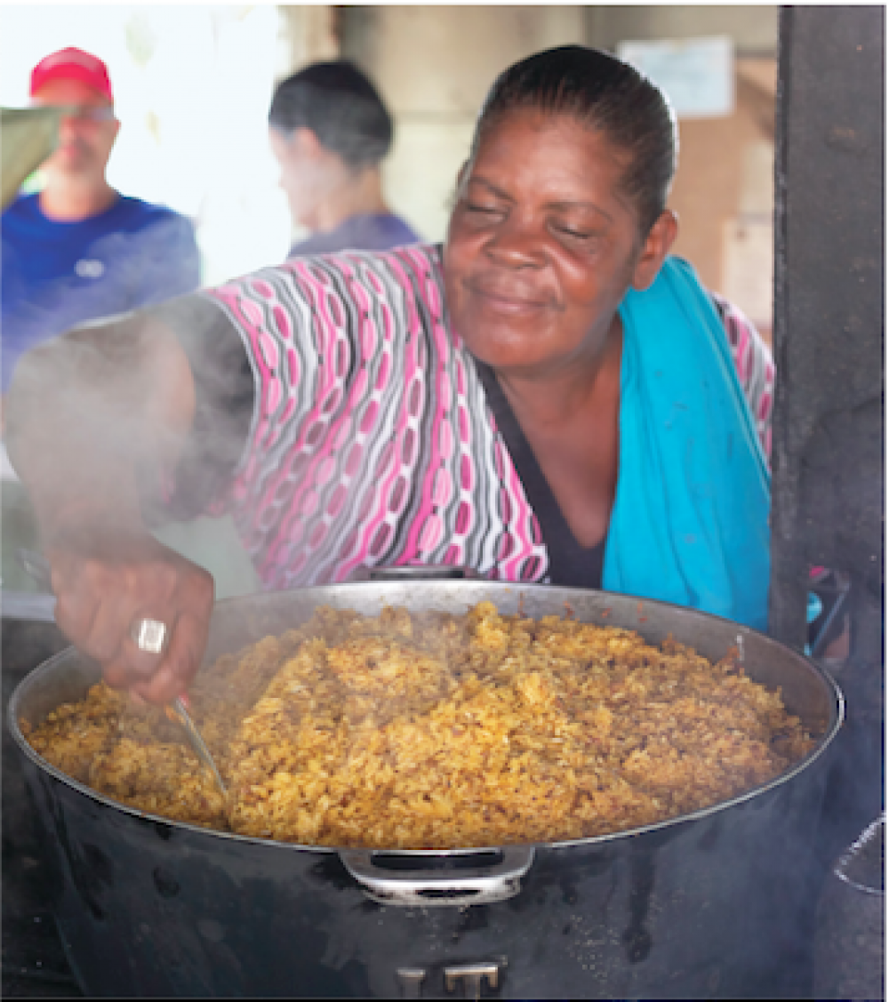 Chef making Sofrito in a large pot.
