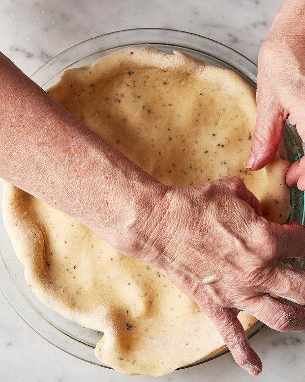 Tomato tart tuck edges of dough into pie plate